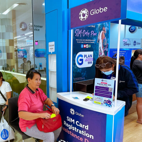 Senior citizen registers 20-year-old SIM at Globe's SIM registration assistance desk in Bacolod